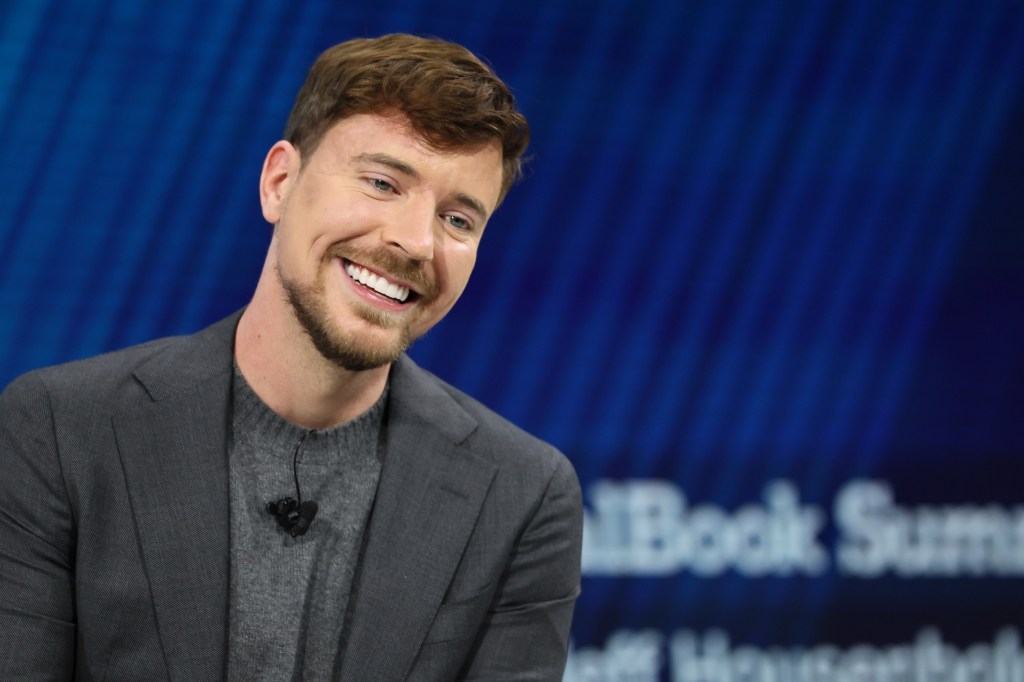 NEW YORK, NEW YORK - DECEMBER 03: MrBeast, Creator, Entrepreneur and Philanthropist Jimmy Donaldson laughs as he speaks onstage during the 2025 New York Times Dealbook Summit at Jazz at Lincoln Center on December 03, 2025 in New York City. (Photo by Michael M. Santiago/Getty Images)