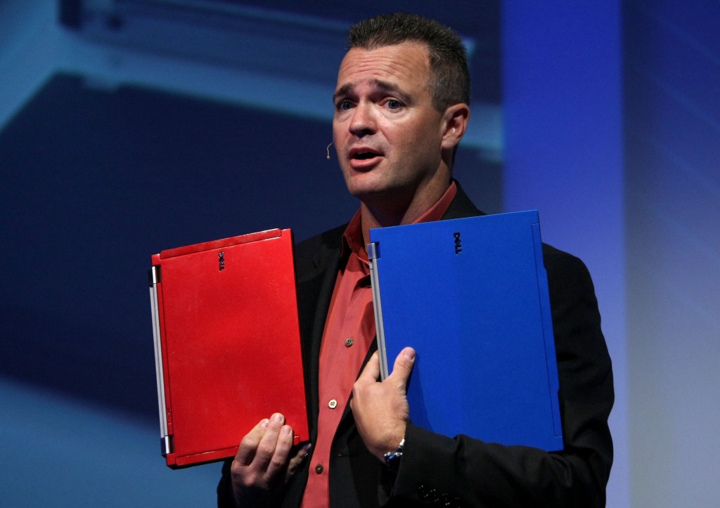 SAN FRANCISCO - AUGUST 12: Jeff Clarke, Dell Senior Vice President and General Manager of Dell Business Product Group, shows 2 color options of the new Dell Latitude E4200 laptop during a Dell product launch event August 12, 2008 in San Francisco, California. Dell announced a new line of its popular Latitude laptops with new features including increased security, backlit keyboards and battery life up to 19 hours. (Photo by Justin Sullivan/Getty Images)