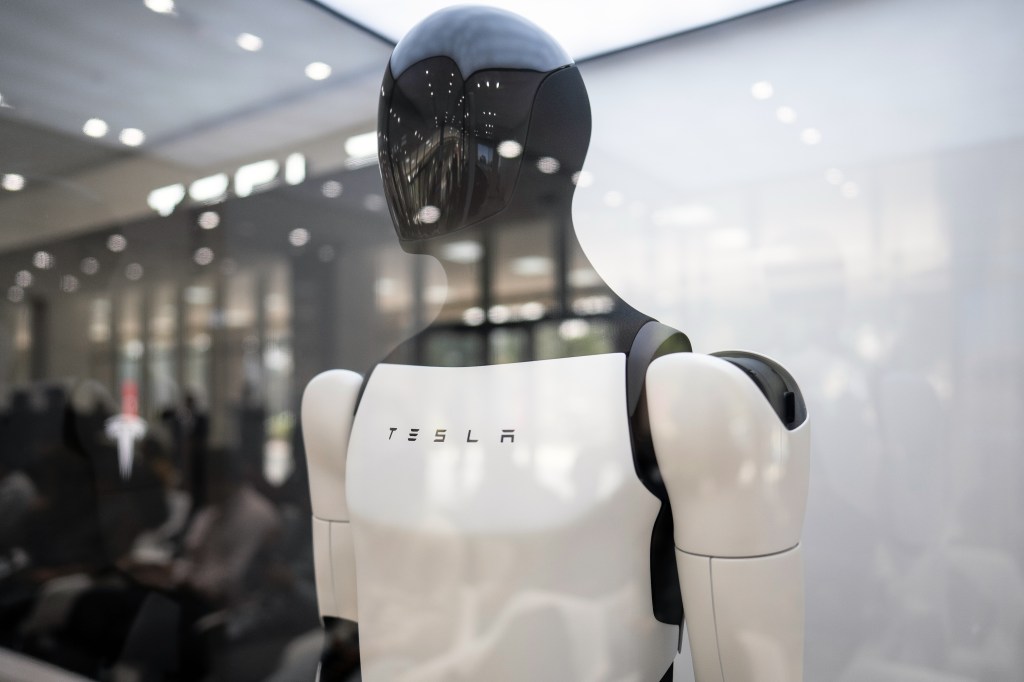 A Tesla Inc. Optimus robot displayed at the company's Experience and Service Center in Gurugram, India, on Wednesday, Nov. 26, 2025. Tesla this month has appointed Sharad Agarwal as the automaker's country head in India, marking a shift in its approach to the market after a muted start to sales in the world's most-populous nation. Photographer: Anindito Mukherjee/Bloomberg