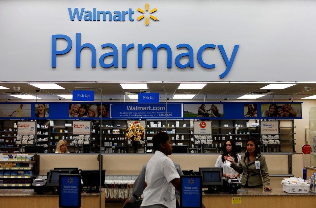 Signage for Walmart Pharmacy attracts customers after the grand opening of the new Walmart discount store in Torrance, California, U.S., on Wednesday, Sept. 12, 2012. The store, which was the first location to open in Los Angeles County since 2006, was built inside of a former Mervyn's clothing location. Photographer: Patrick Fallon/Bloomberg