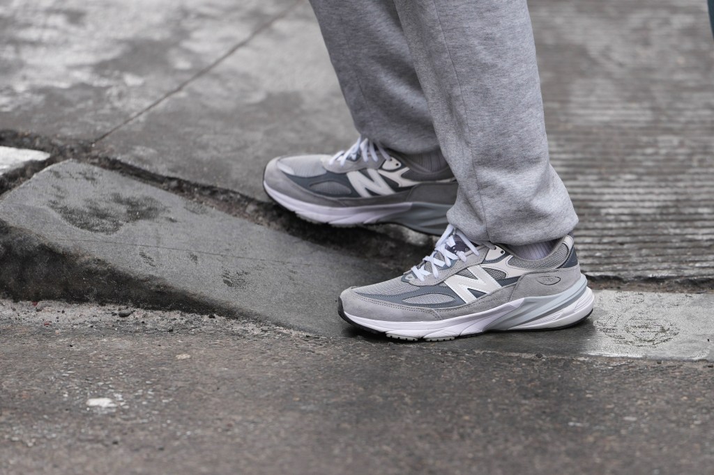 NEW YORK, NEW YORK - FEBRUARY 15: A guest wears gray cotton sweatpants, gray mesh and suede sneakers shoes with white laces and a white rubber sole from New Balance, outside Diotima, during New York Fashion Week, on February 15, 2026 in New York City (Photo by Edward Berthelot/Getty Images)